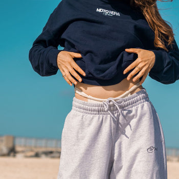 woman wearing navy sweatshirt and gray sweatpants